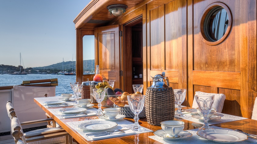 luxury dining area on a deck on a S/Y TRINAKRIA for charter