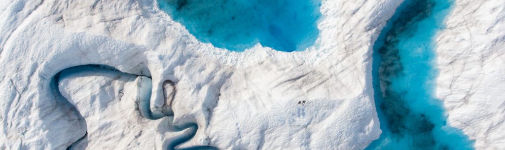 Drone shot over the Greenland Ice Sheet of crystal clear super glacial lakes and the rushing rivers that feed them Luxury Yacht Charters Greenland