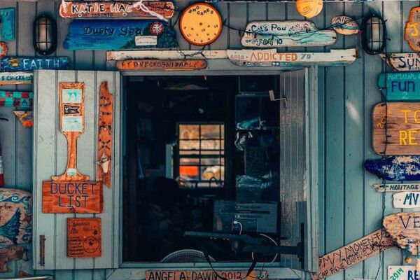 Charming Caribbean shack-style building with a plethora of wood sign decorations